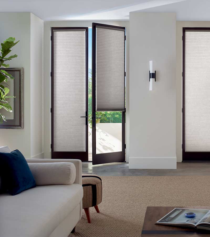 partially open glass door with gray cellular shades in Chicago, IL