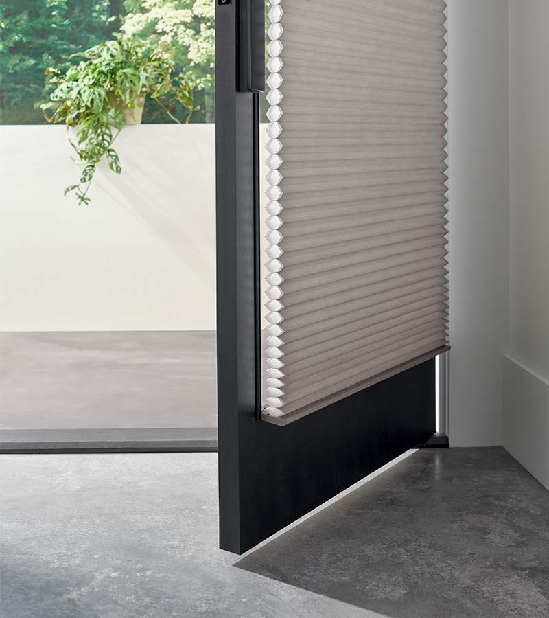 zoomed in detail of open front door with glass covered by gray honeycomb shades in naperville, IL