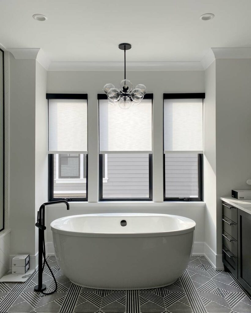 white roller shades black headrail bathroom