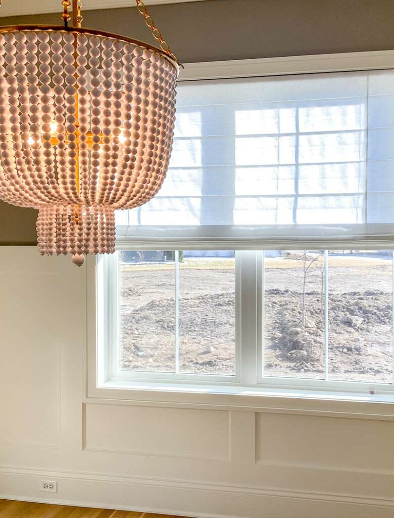 pink beaded light fixture and large picture window in new home build Portland, OR