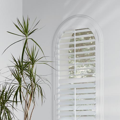 skyline-window-coverings-hunter-douglas-newstyle-hybrid-shutters-specialty-shapes arched window with white shutters