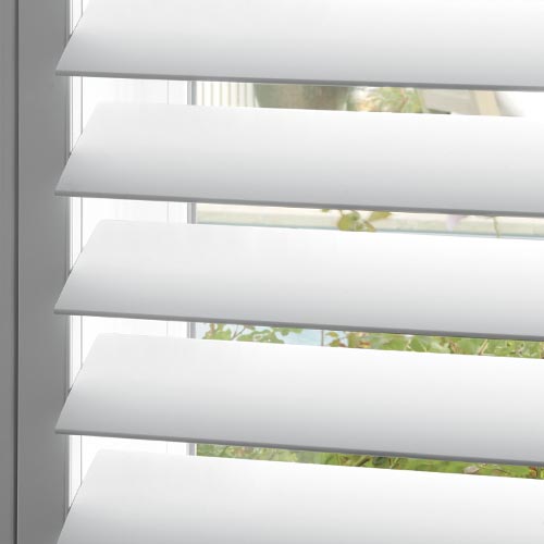 close up of white shutter louvers open