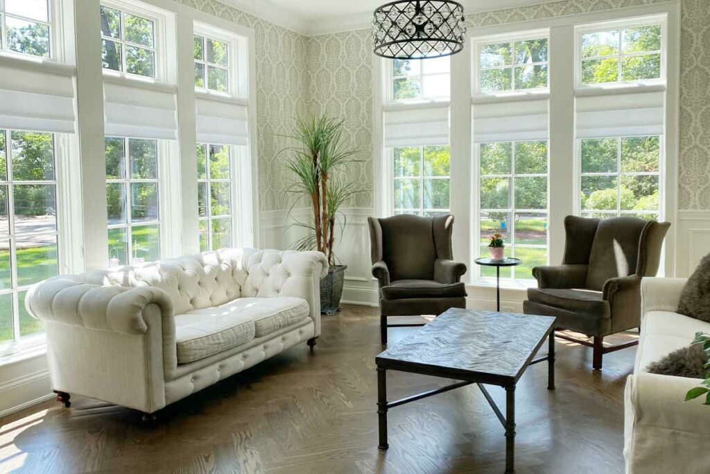 Traditionally styled living room with floor to ceiling roman shades in Chicago, IL