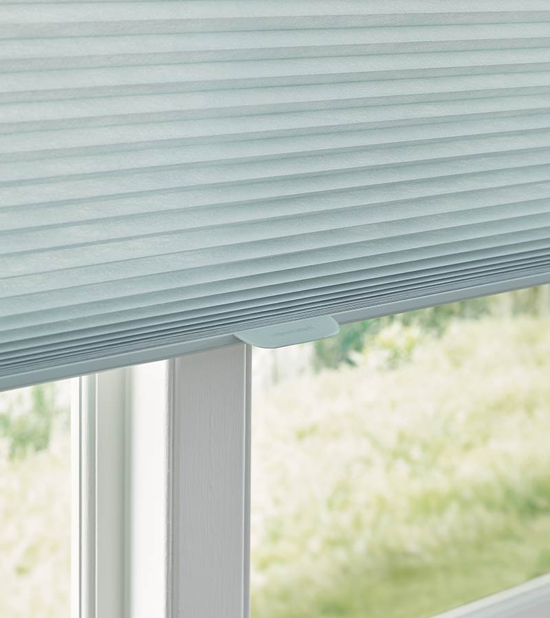 detail of blue cellular shade with cordless lift system in Chicago, IL