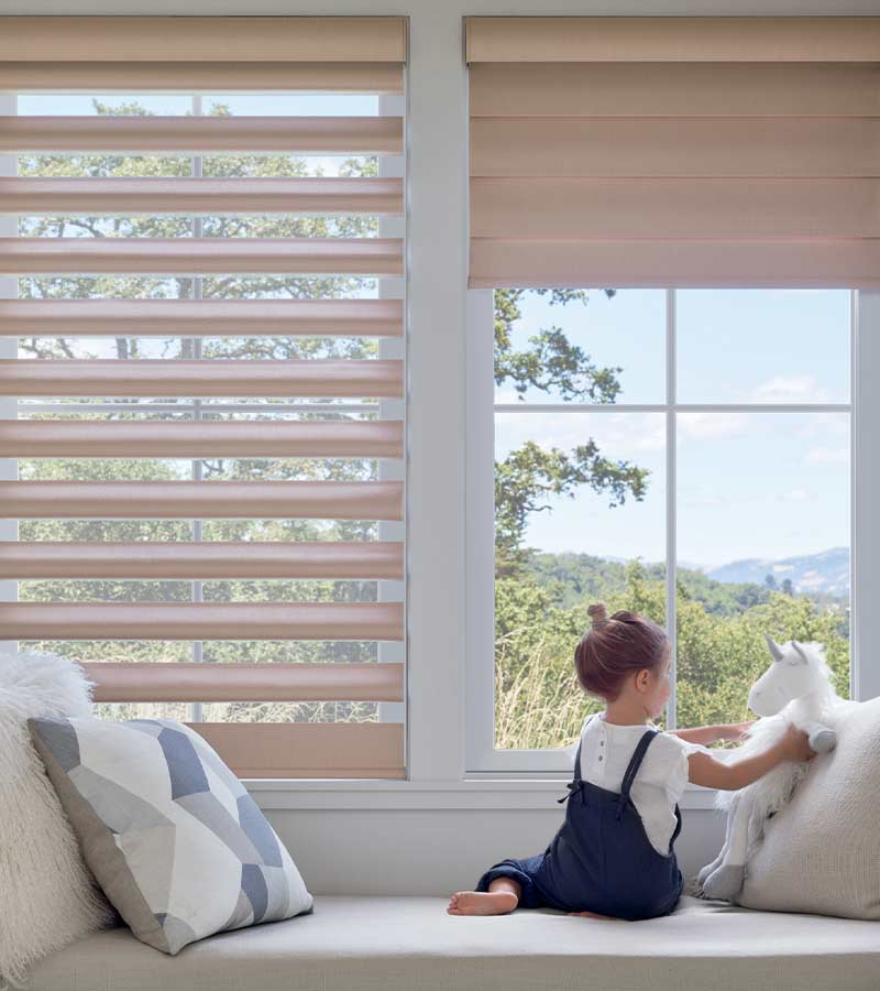 girl playing with toy in window seat with cordless shades Vancouver, Washington