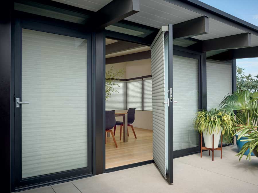 exterior view of home with black window trim and white window shades