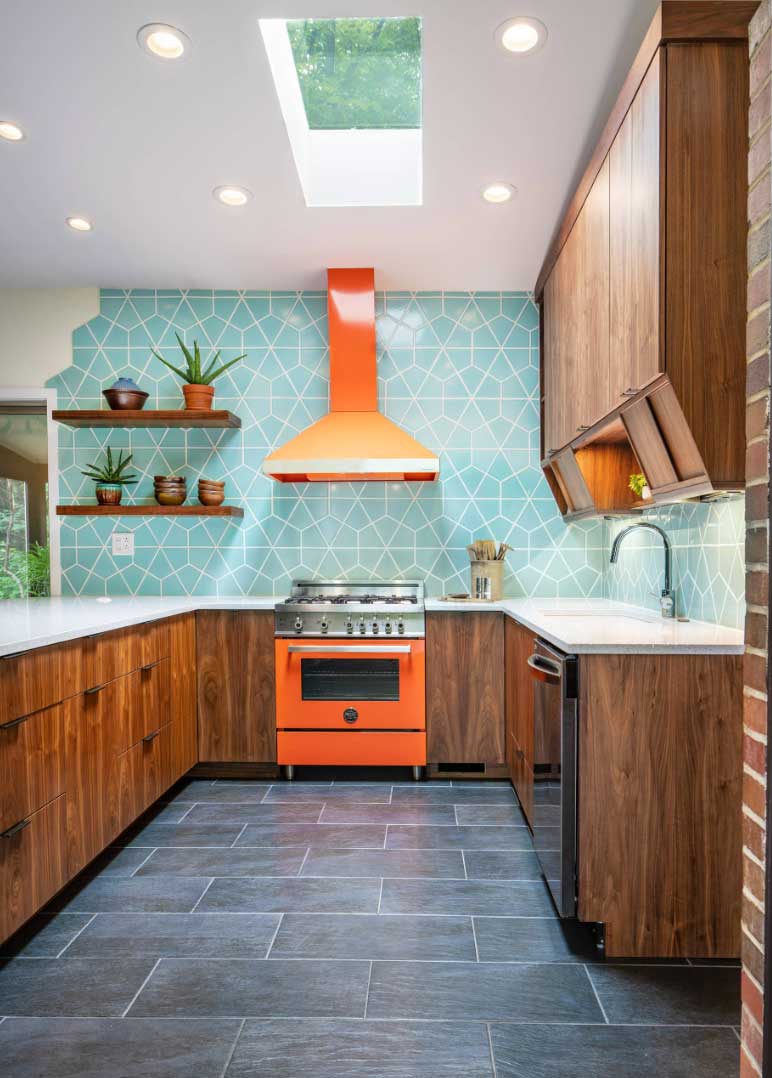 midcentury modern kitchen with aqua wall and orange appliances