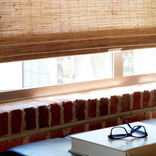 cordless woven shades adjusted by hand