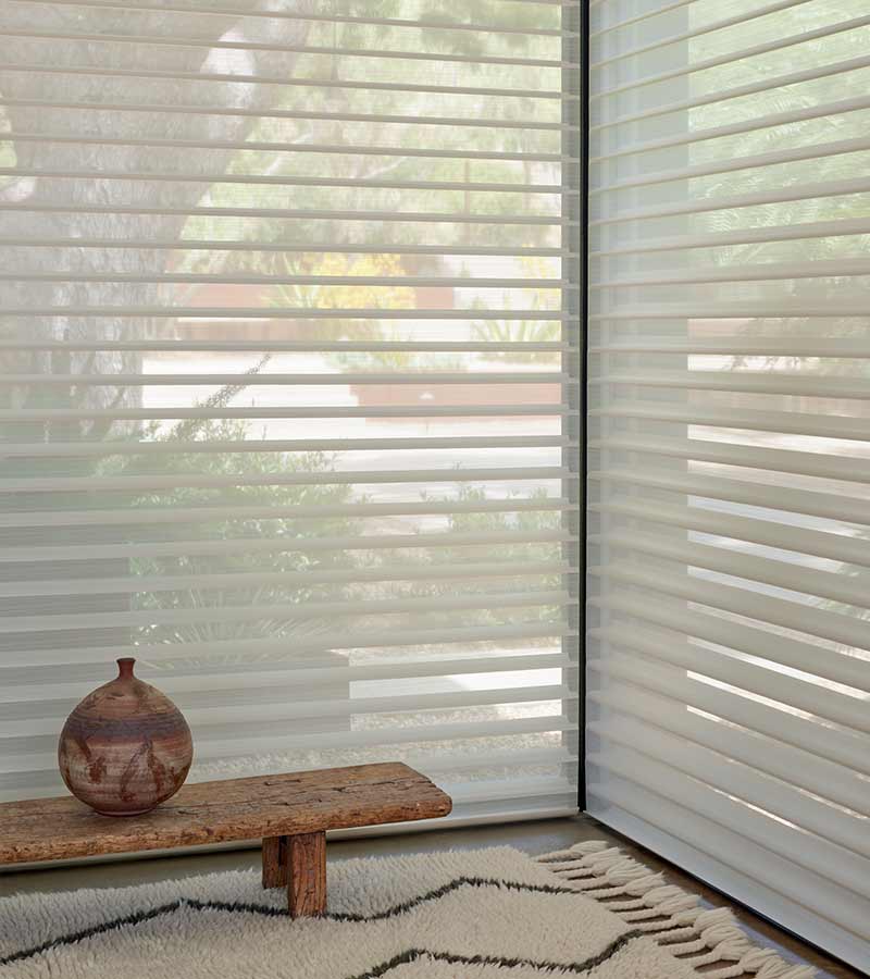 floor to ceiling light diffusing window shades with small bench and pottery in Chicago, IL