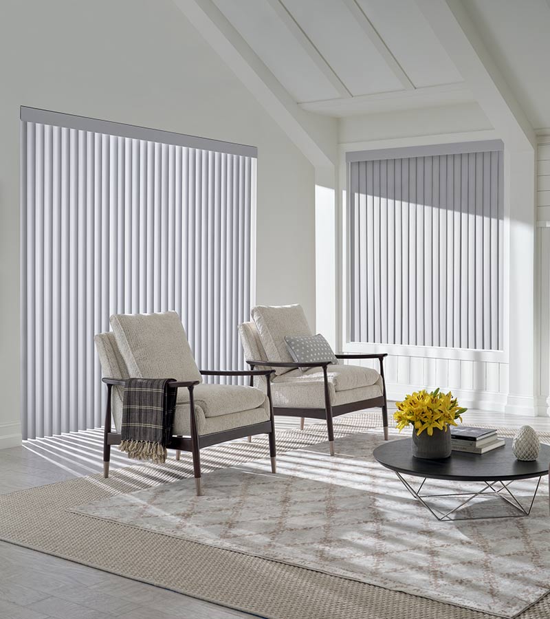 interior of living room space floor to ceiling window and modern armchairs in West Hollywood, CA