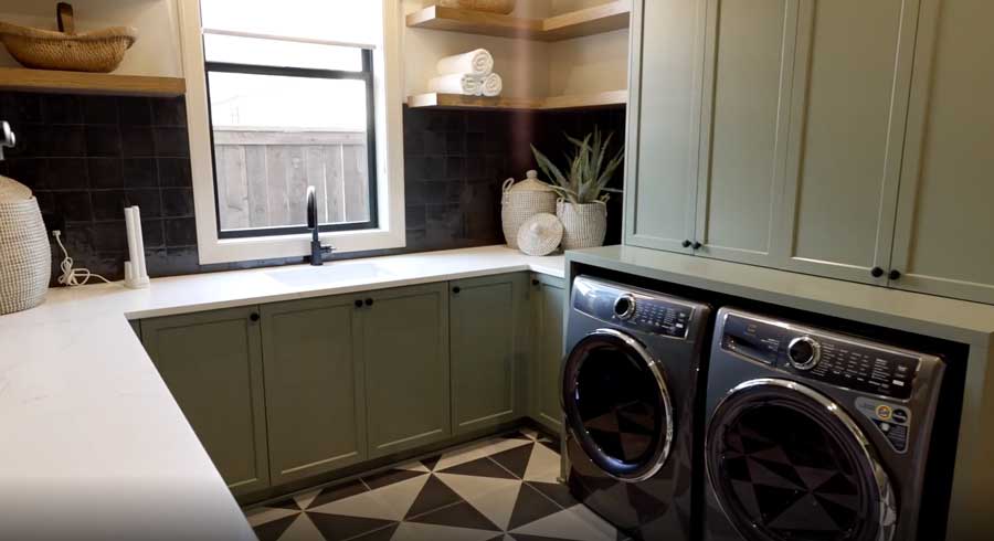 green laundry room with low profile roller shade behind sink