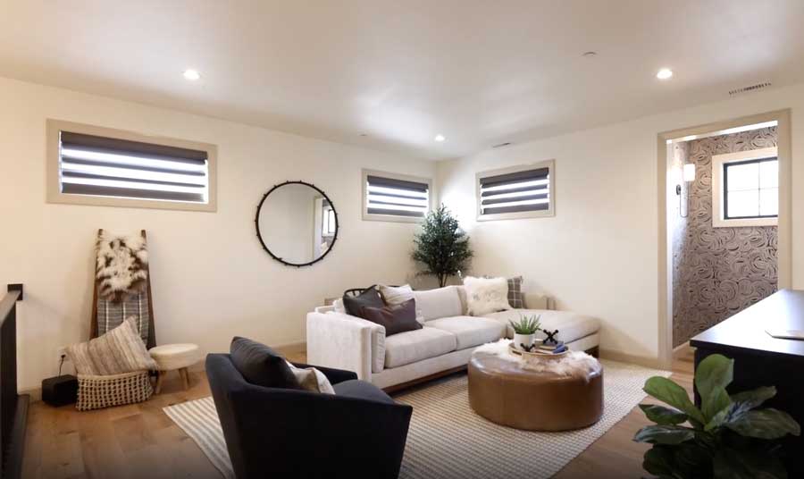 second floor loft space with dark brown window coverings