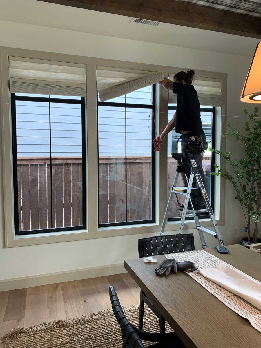 professional installer connecting hard-wired remote control shades