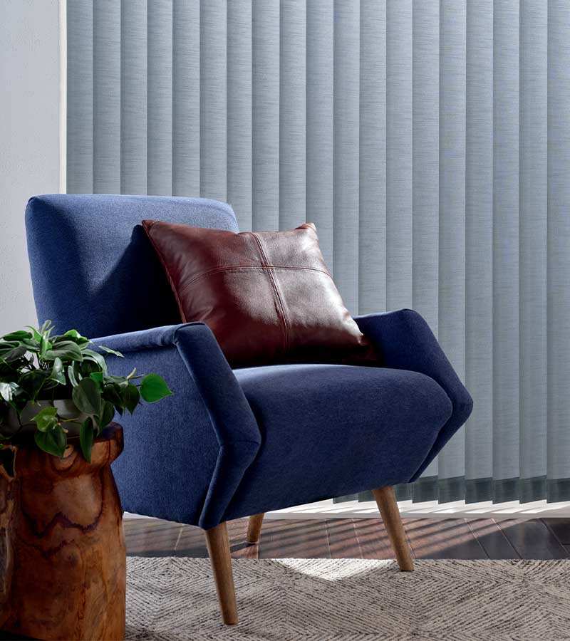 blue arm chair in front of blue window shadings in Los Angeles, CA