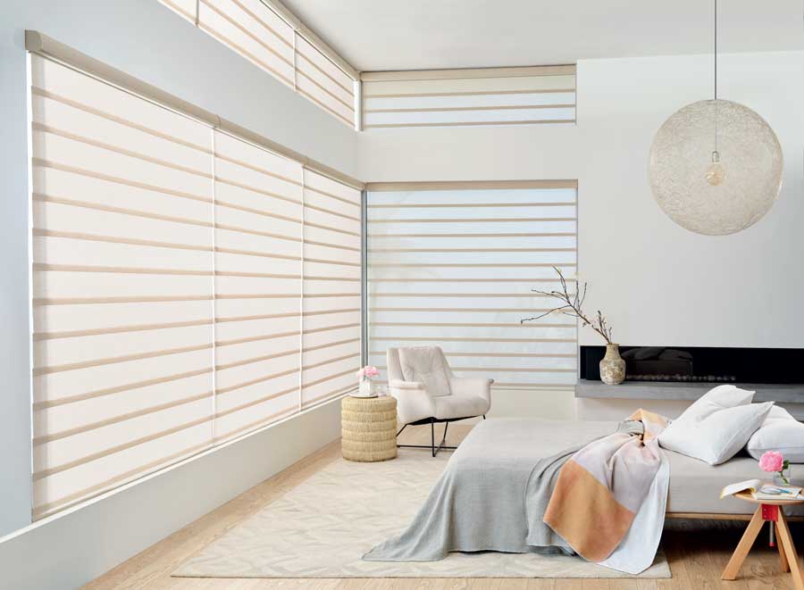 Bedroom with rolling roman shades