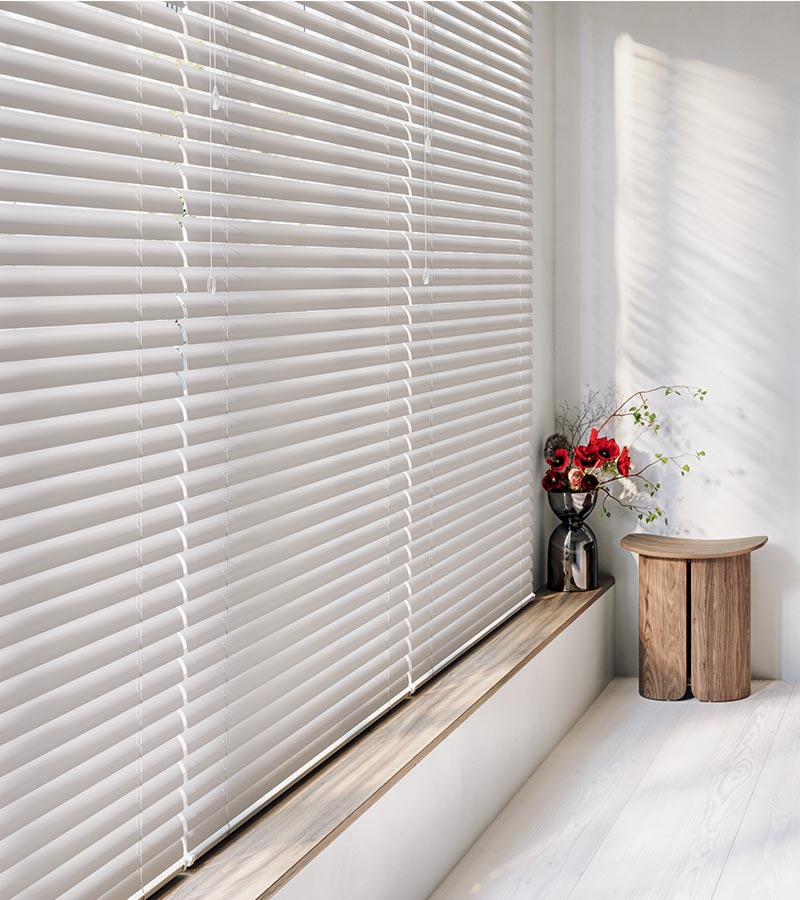 detail of large window covered by blinds in a soft white hue in Winnetka, IL