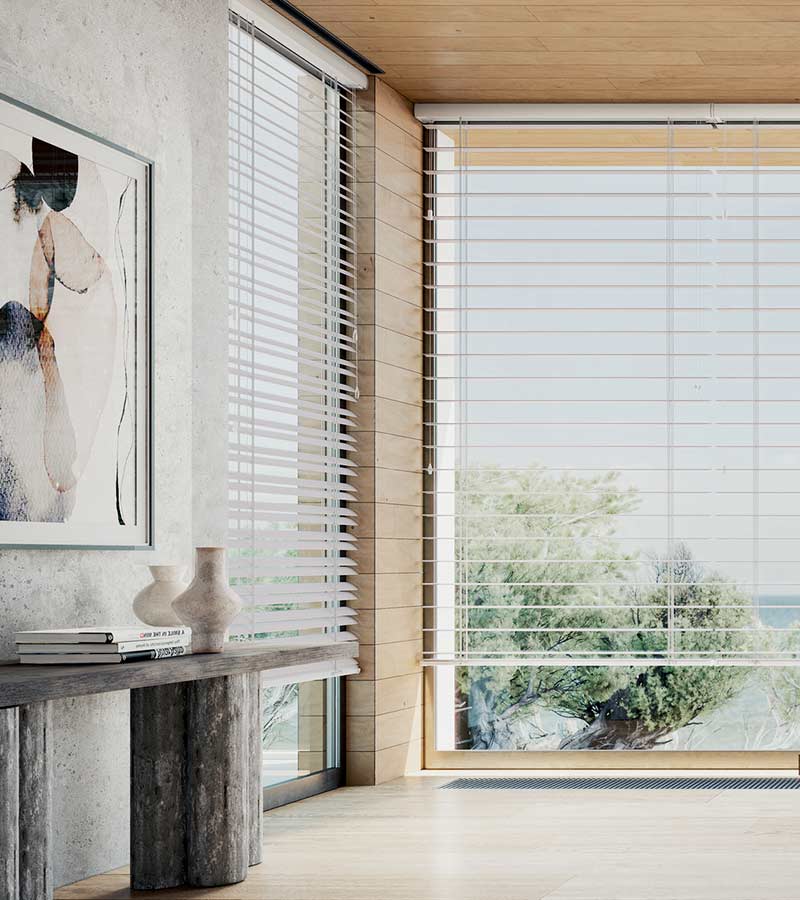 detail of primary bedroom corner windows with white horizontal blinds