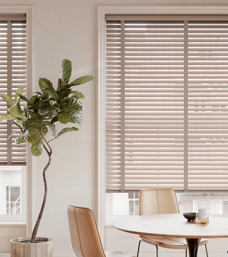 modern seating and dining area with large windows facing out into the city