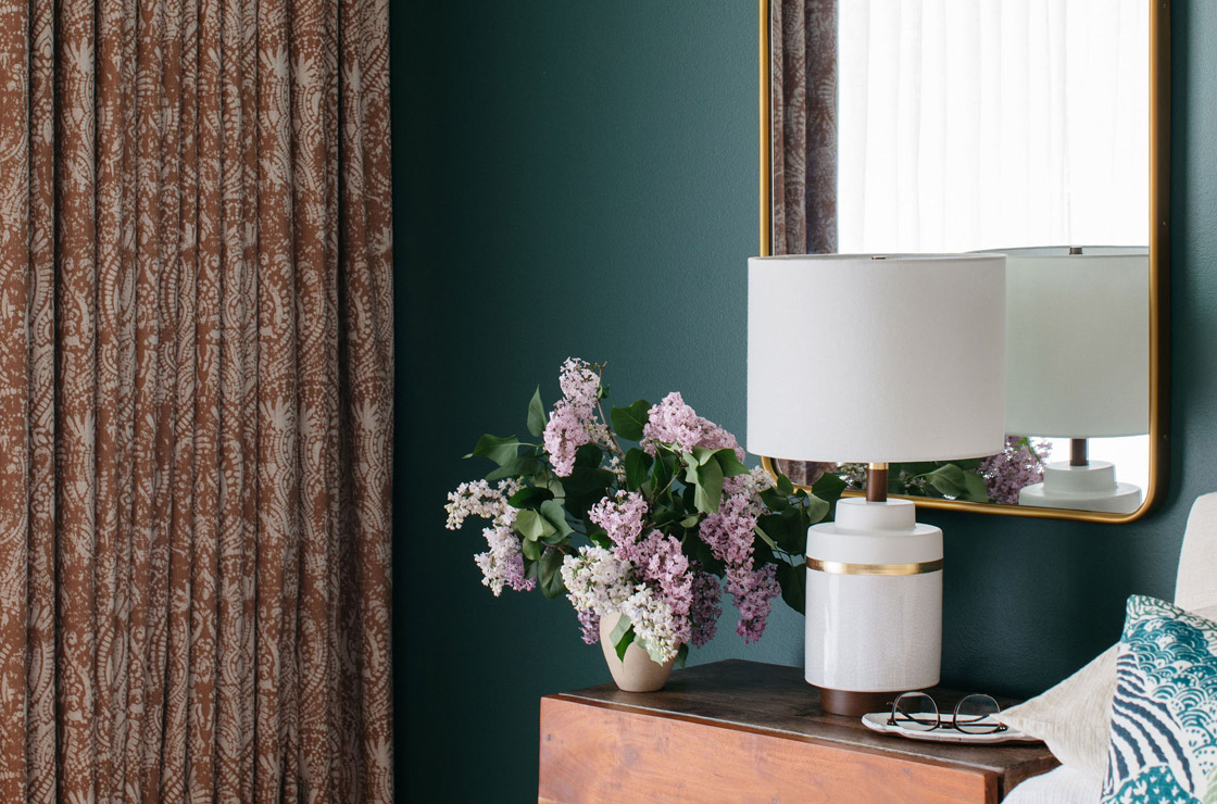 bedroom with emerald walls and gold and white accents