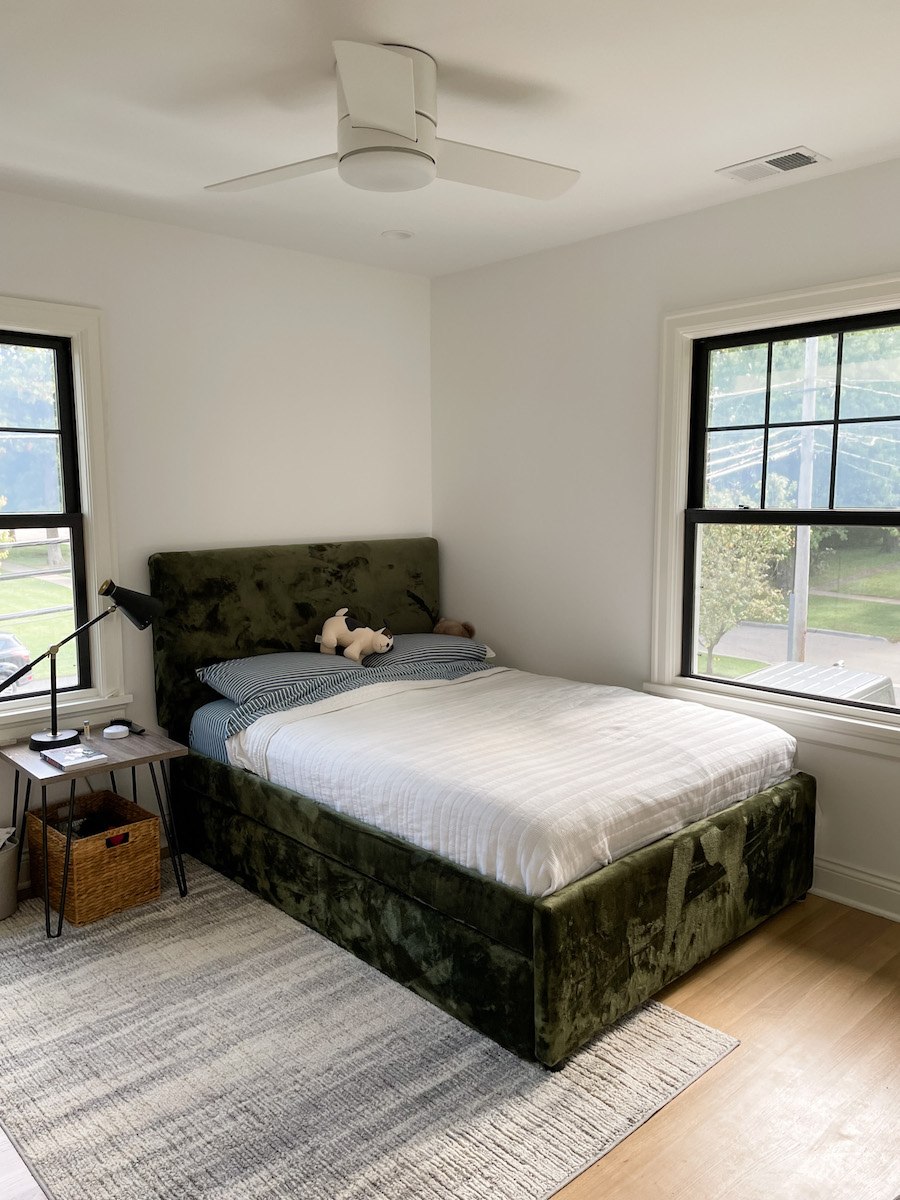 two windows with black trim in boys bedroom