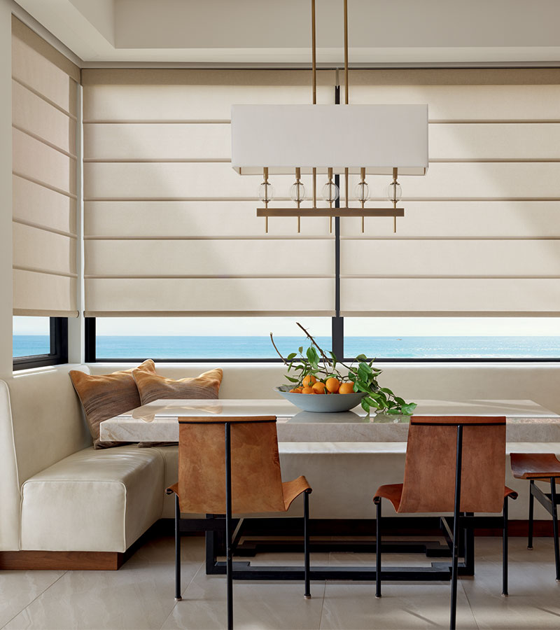 dining area with corner windows with shades halfway lowered