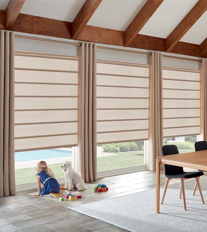 dining room with large windows and drapery panels floor to ceiling