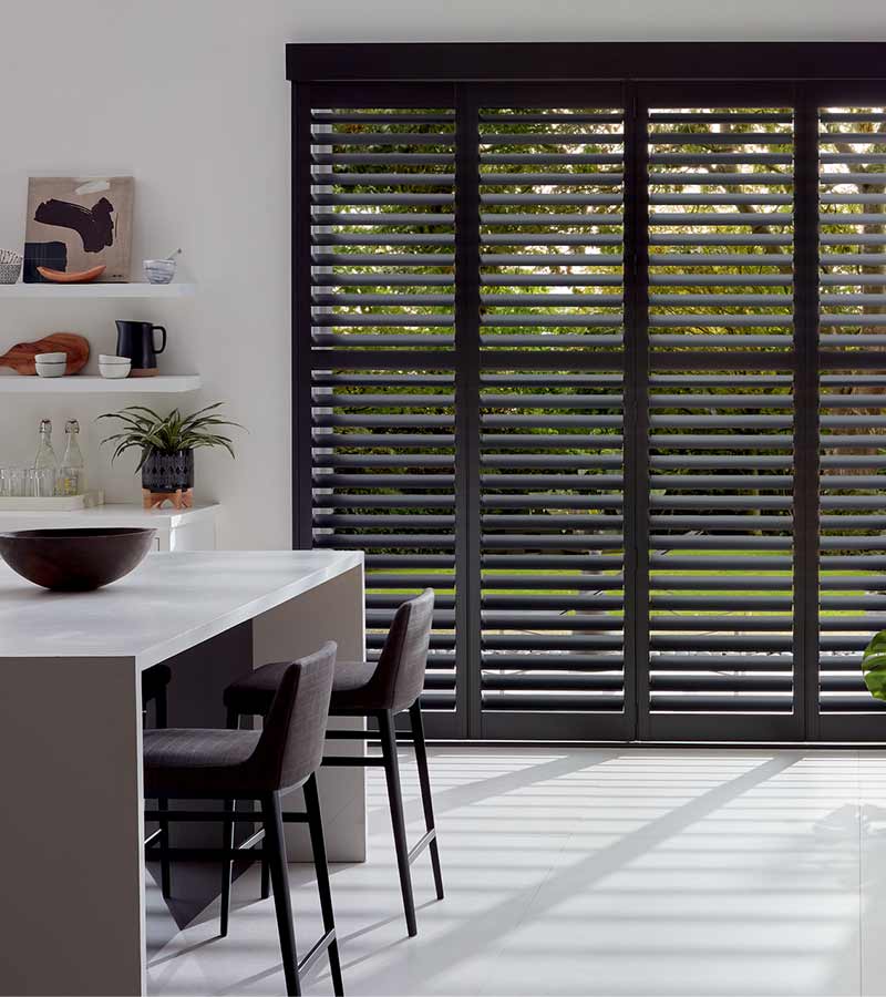 black shutters covering patio door in kitchen space