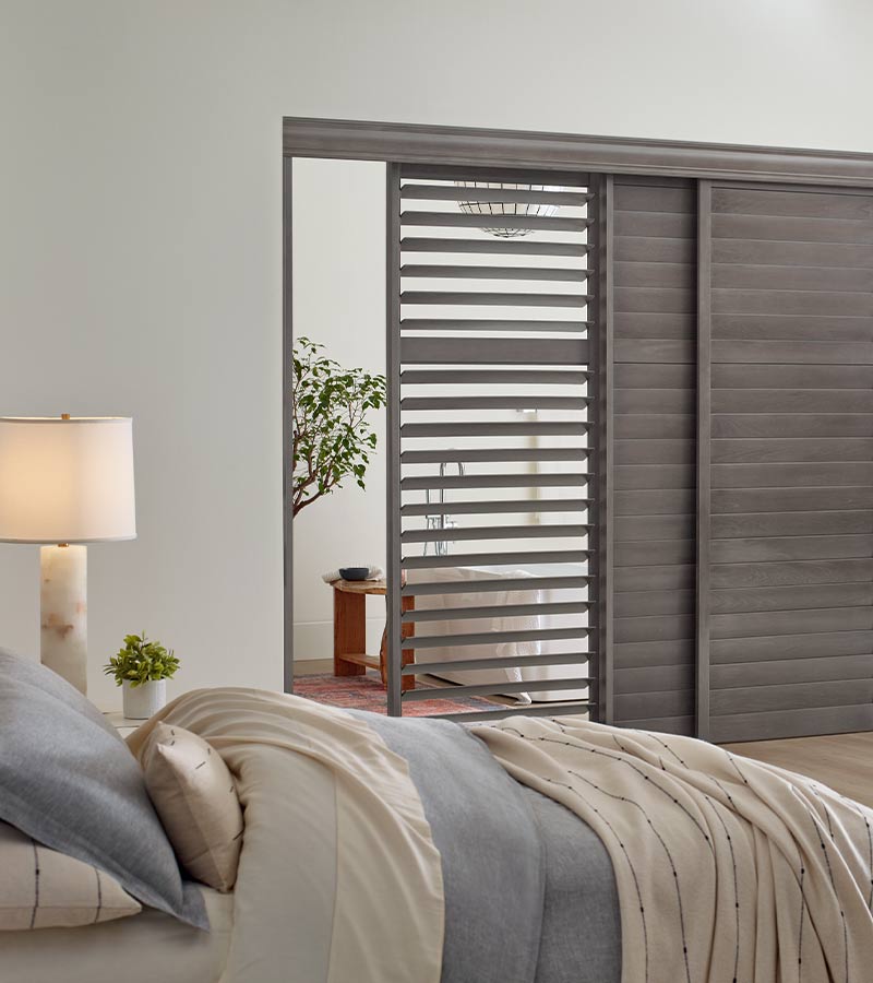 gray wood shutters on sliding glass door for guest bedroom