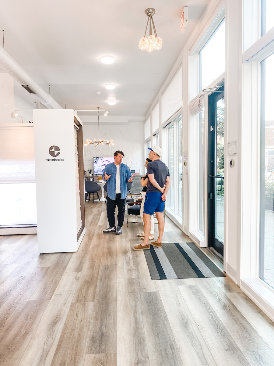 couple looks at full size displays of window coverings