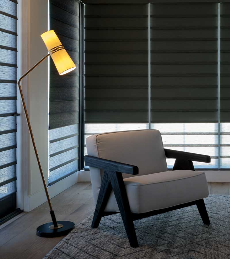 room darkening shades chair with lamp turned on pointed at it