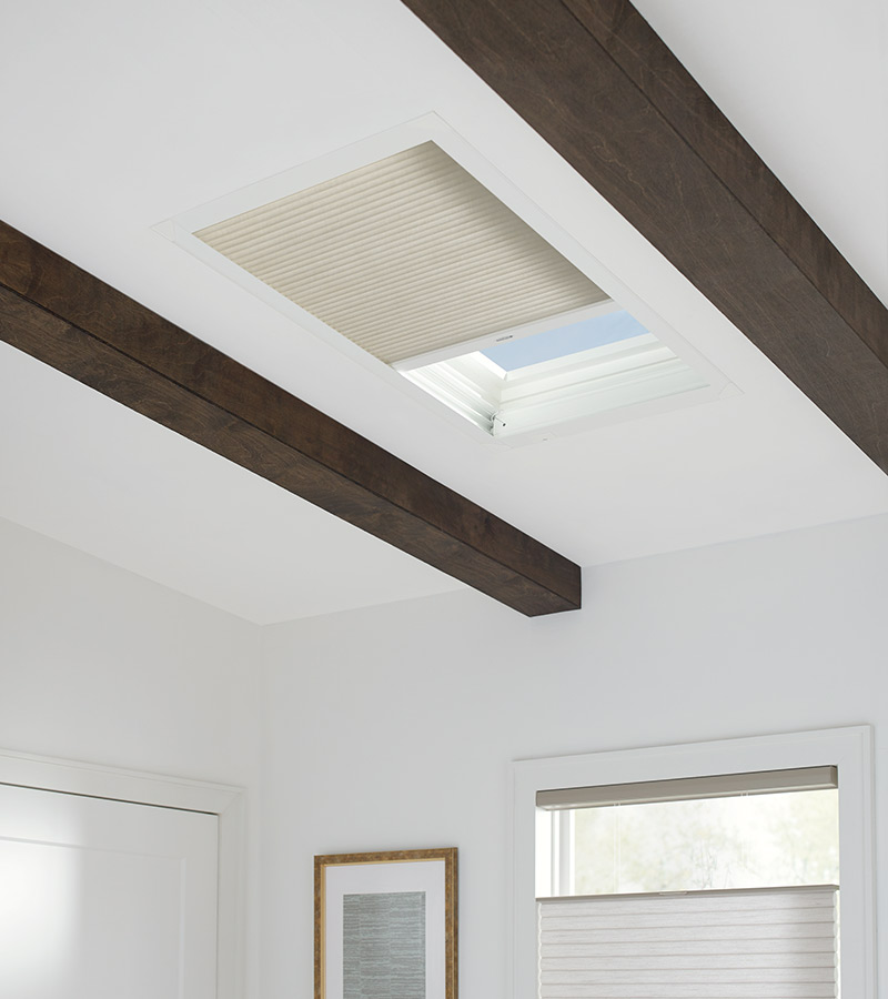 beige honeycomb shades on skylight window