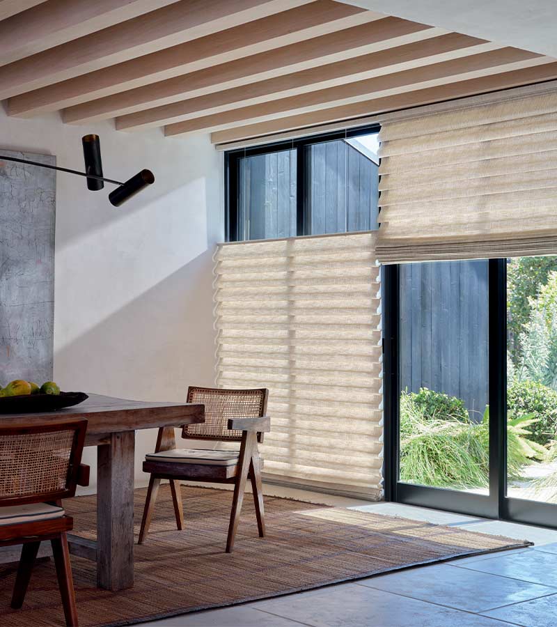 soft fabric window shades on black trim patio doors overlooking outdoor space