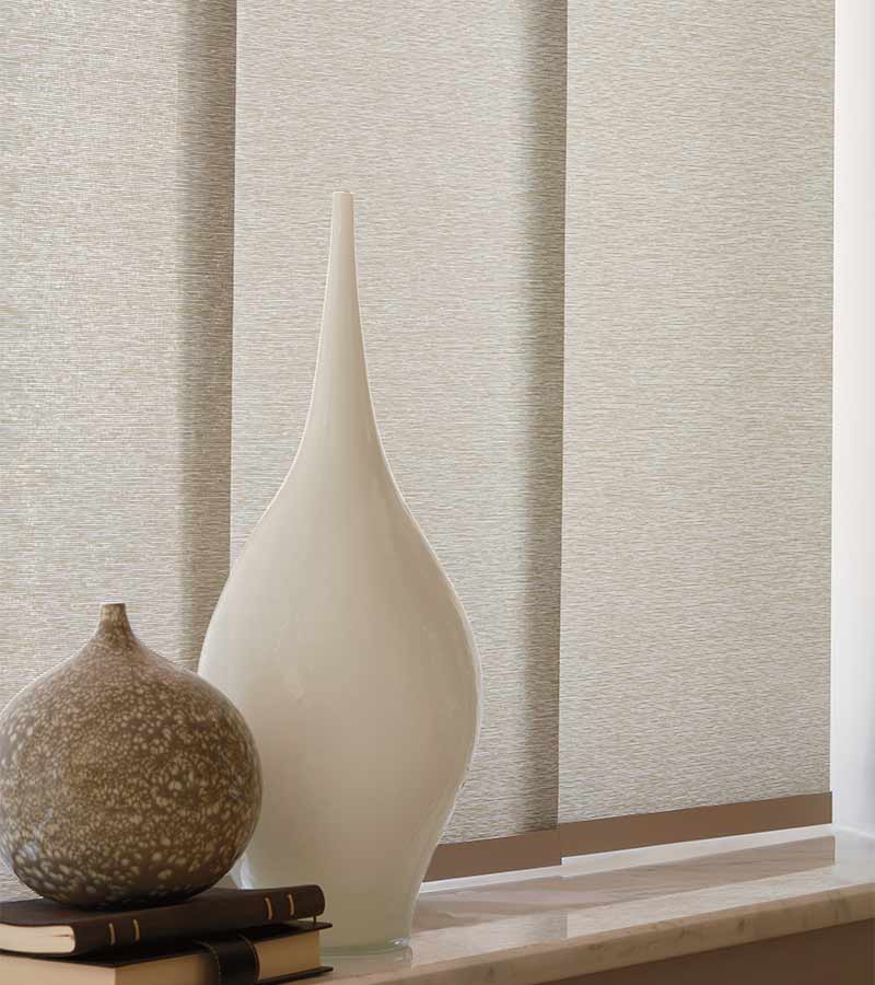 Beige fabric panel tack blinds next to neutral home accents in Hinsdale IL