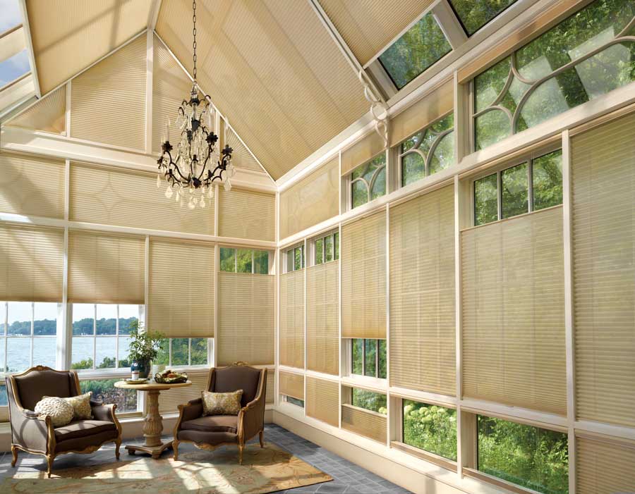 glass sunroom windows covered with honeycomb shades