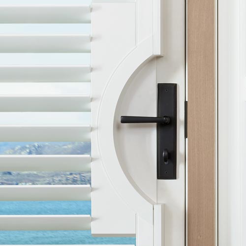 palm-beach-polysatin-shutters-door-handle-cutouts-hunter-douglas-skyline-window-coverings black lever door handle with rounded door handle cut-out for shutters