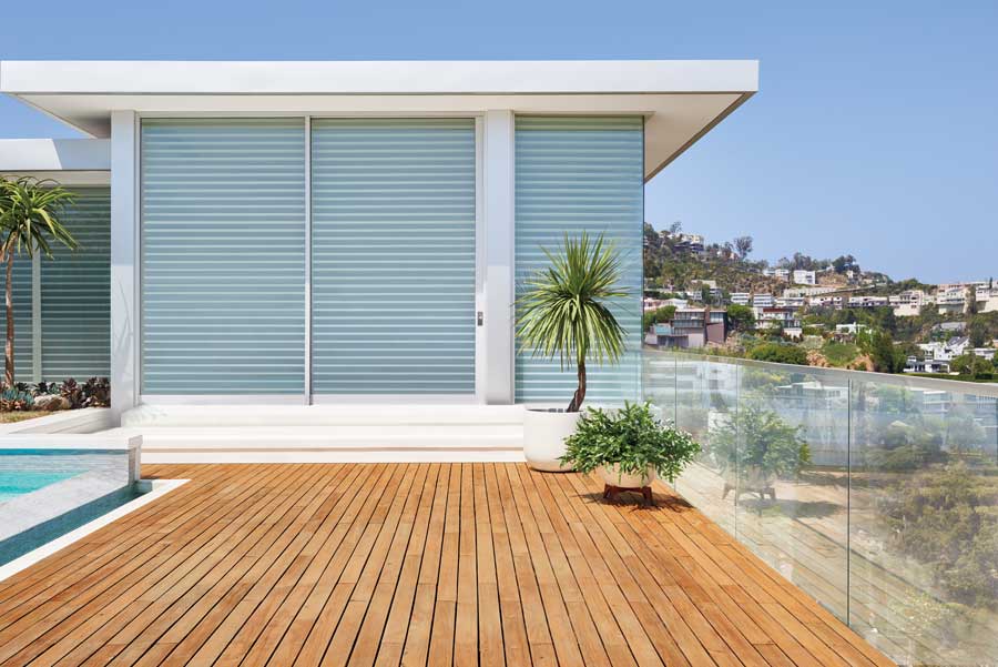 exterior view of patio room with sheer shades inside