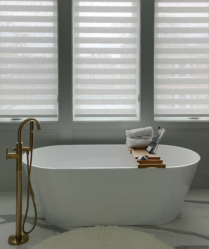 designer banded shades on triple windows in bathroom over tub