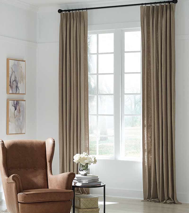 neutral brown side panel curtains on living room windows