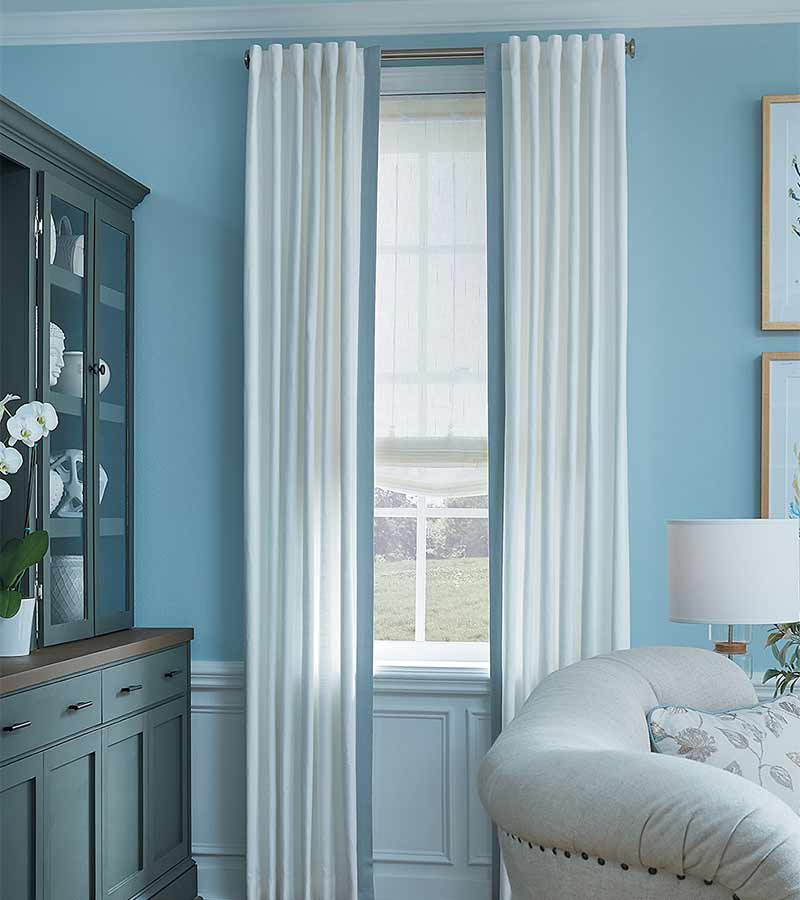 white and blue curtains panels in blue living room