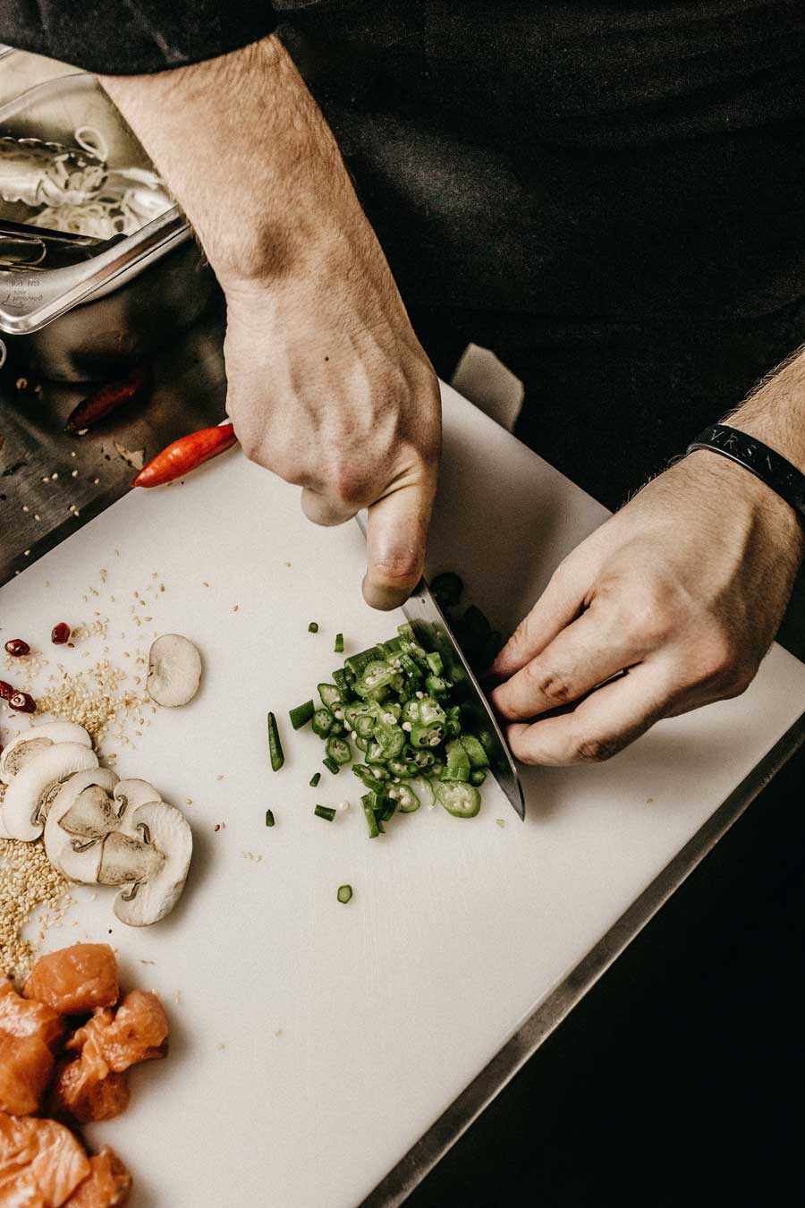 chef cuts peppers for recipe