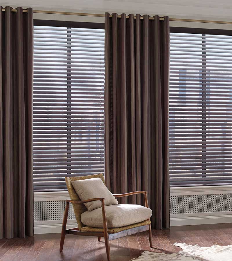 mahogany color blinds framed by dark brown drapery panels