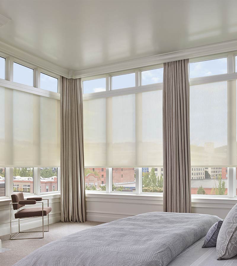 loft apartment downtown with large roller shade blinds and beige drapery panels