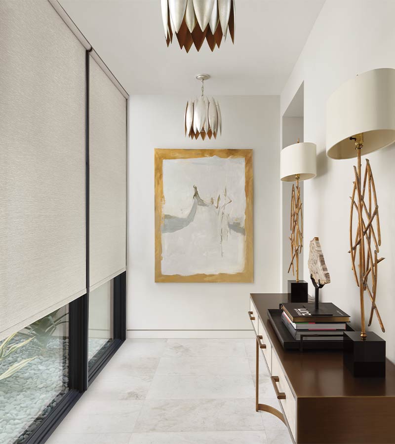 hallway with large windows facing outdoors with white fabric shades