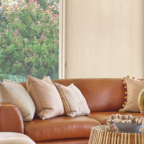 contemporary living room with backdrop of vertical cellular shades in Malibu