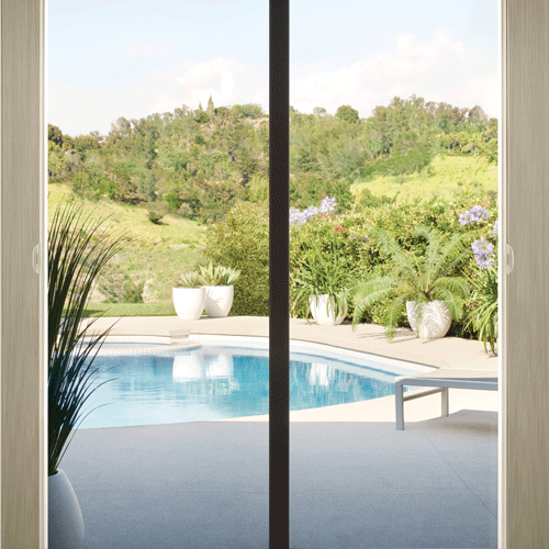 duette-honeycomb-shades-with-vertiglide-stacking-hunter-douglas-skyline-window-coverings vertical cellular shades coming across sliding door window