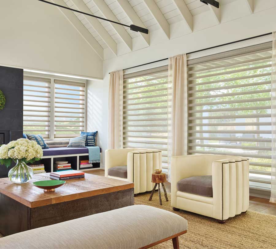 pirouette shades on large living room windows with side drapes in Malibu home