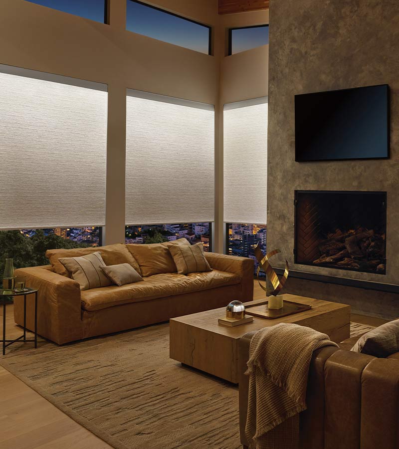 light illuminated window shades in a modern home and leather couches