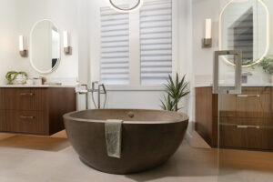 Parade of homes bathroom with white modern roman shades and floating vanities