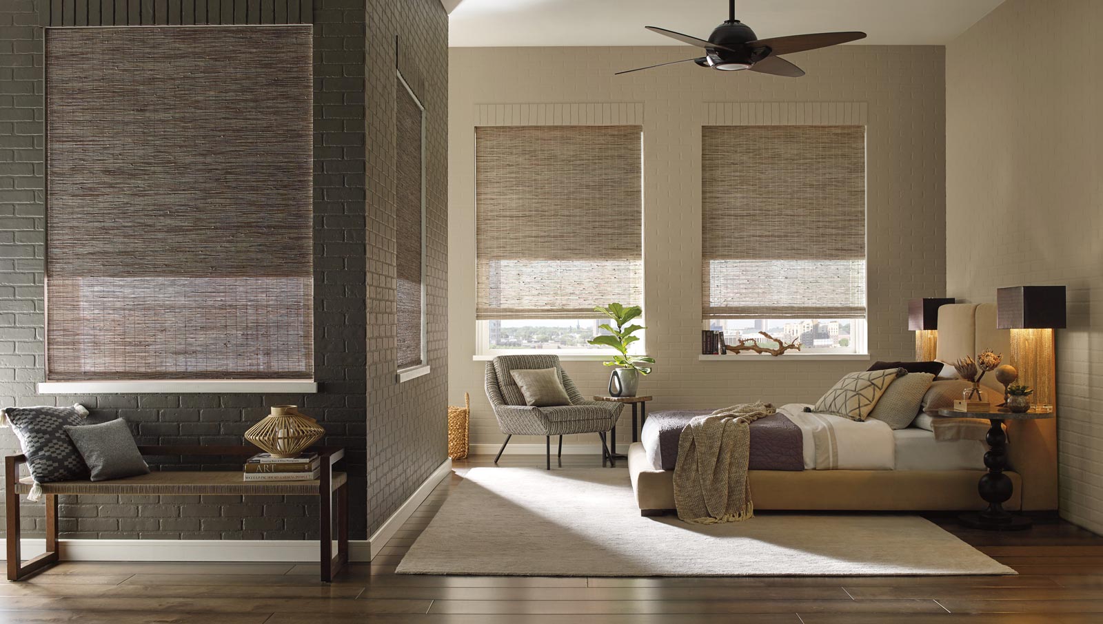 cozy spaces created in large bedroom with sconces, blankets, area rugs and woven shades in Chicago IL
