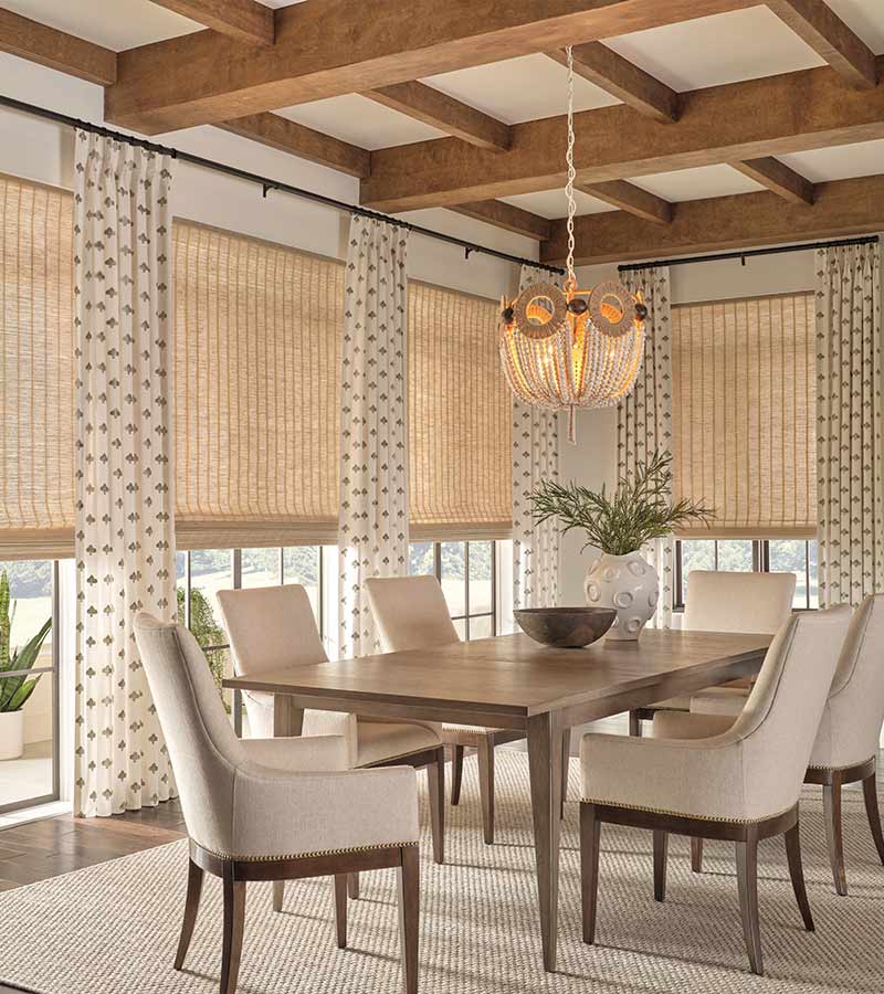 side drapery panels and window shades layered in a cozy modern dining room